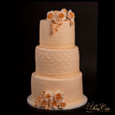 wedding cake with beige roses and lace
